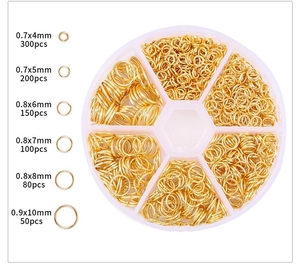 Detail view of gold open jump ring assortment in a 6-grid round storage case for DIY jewelry