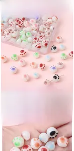 Macro shot of colorful acrylic cat paw beads with glossy finish for DIY jewelry crafting