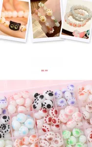 Macro shot of colorful acrylic cat paw beads and DIY handmade bracelets in a storage box