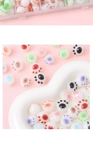 Macro detail of acrylic cat paw beads in vibrant colors for DIY jewelry making