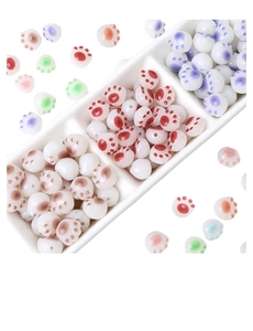 Detailed view of colorful acrylic cat paw beads in various pastel shades for DIY jewelry