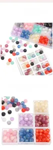 Macro detail of mixed colorful 11x8mm resin beads in a clear plastic organizer box