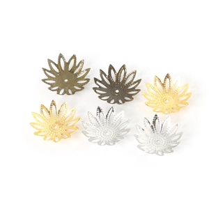 Detail of floral hollow metal bead caps in gold, silver, and bronze finishes for DIY jewelry