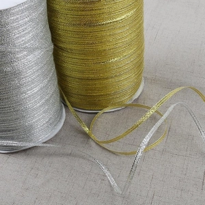 Metallic gold and silver glitter ribbons on rolls for DIY gift wrapping and hair accessories