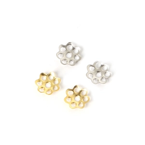 Close-up of gold and silver six-petal hollow flower bead caps for DIY jewelry making