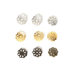 Close-up of eight-petal hollow metal flower spacers in silver, gold and bronze colors