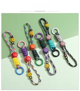 Detail of colorful woven paracord lanyards with smiley faces and heart beads