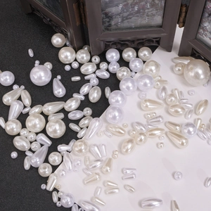 Detail of assorted beige and white ABS faux pearls in round and teardrop shapes for DIY jewelry