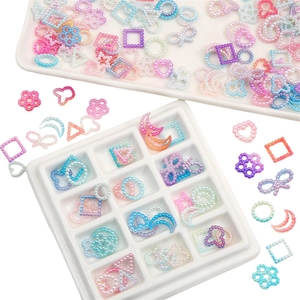 Close-up of colorful gradient faux pearl flatback beads in heart and star shapes