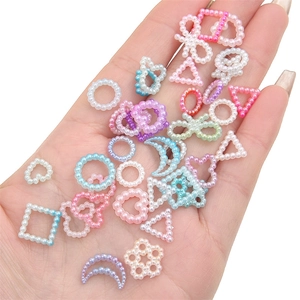 Colorful ABS faux pearl DIY charm kit with heart, star and moon shapes held in hand