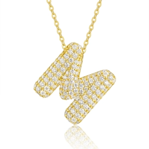 Close-up of golden letter M pendant necklace with shimmering pavé micro-inlaid zircon