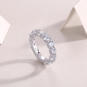 Detailed macro view of S925 sterling silver eternity ring with prong-set moissanite stones