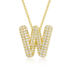 Macro shot of gold letter W pendant encrusted with sparkling cubic zirconia on a cable chain