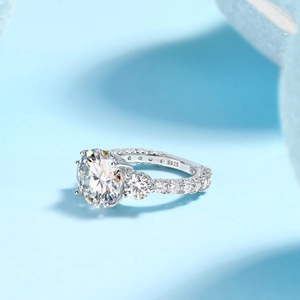 Detail view of S925 sterling silver three-stone ring with sparkling moissanite gems