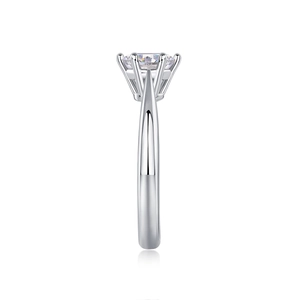 Detailed side view of six-prong classic silver engagement ring with brilliant round gem