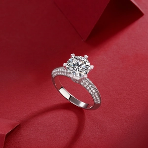 Close-up of S925 sterling silver six-prong lab diamond ring on red textured background
