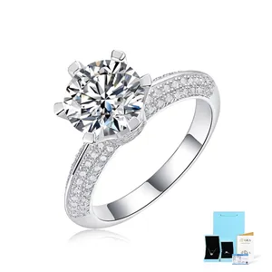 Detail of S925 sterling silver six-prong round diamond ring with side stone accents