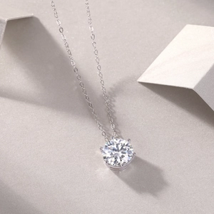 Detailed view of S925 silver necklace with six-prong moissanite pendant on a minimal base