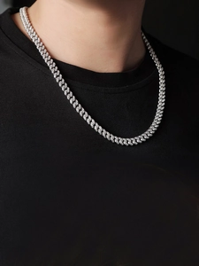 Close-up of S925 silver Cuban link chain necklace with Moissanite pavé on model