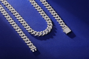 Detail of S925 sterling silver cuban link chain with moissanite diamonds on blue leather