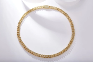 Detail of S925 silver Cuban link chain in gold finish with iced out moissanite settings