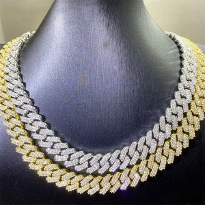 Close-up of hip hop cuban link necklace with iced out moissanite in gold and silver