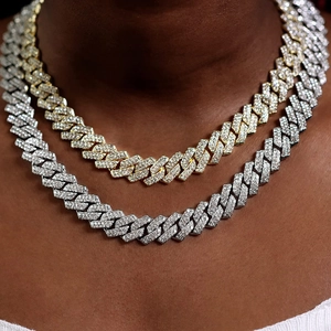 Close-up of Iced Out Hip Hop Cuban Link chains in gold and silver finish with high-density stones