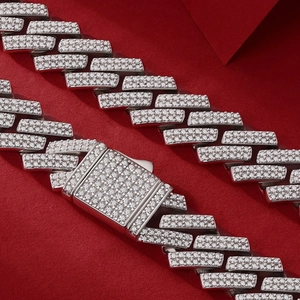 Macro shot of silver Cuban link chain featuring iced out pavé set moissanite stones