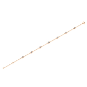 Detail of rose gold bubble bracelet featuring bezel-set round moissanite gemstones