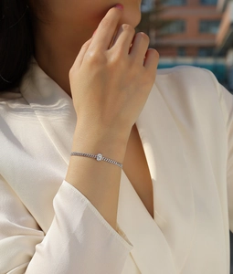 Close-up of a S925 sterling silver Cuban link bracelet with an oval moissanite stone