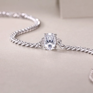Macro view of oval-cut moissanite centerpiece on a polished S925 sterling silver Cuban chain