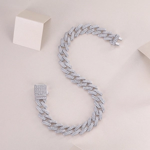 Macro shot of silver Cuban link bracelet with iced-out pave moissanite and square clasp