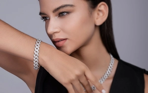 Close-up of Cuban link necklace and bracelet set with white moissanite on a model