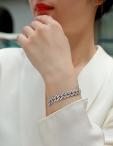 Close-up of S925 sterling silver Moissanite Cuban link bracelet on female model wrist