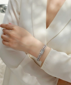 Lifestyle shot of a shimmering silver S925 moissanite Cuban link bracelet on a wrist