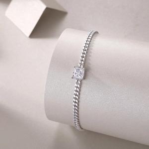 Close-up detail of sterling silver moissanite bracelet with square stone and curb chain