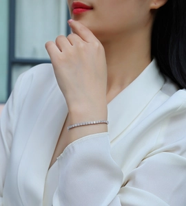 Close-up of S925 sterling silver tennis bracelet with moissanite pavé on a female wrist