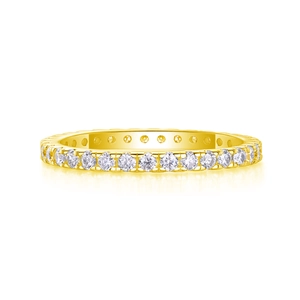 Macro view of gold plated eternity band featuring claw-set round moissanite stones