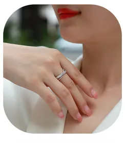 Close-up of S925 silver moissanite ring with dual-band crisscross pavé diamonds on finger