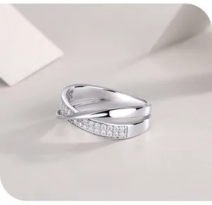 Macro shot of silver 925 ring featuring a dual cross design with pavé set white zirconias