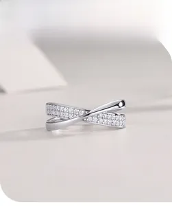 Macro shot of silver moissanite ring with crisscross design and claw setting detail