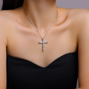 Elegant 925 sterling silver cross pendant necklace with moissanite stones on a female model