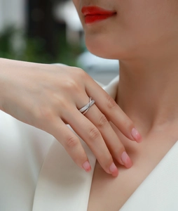 Close-up of elegant silver criss-cross ring with micro-pave stones on model's finger