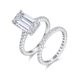Macro view of emerald-cut moissanite wedding ring set with pavé diamonds in S925 silver