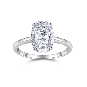 Macro shot of oval cut moissanite ring with four-prong setting in polished silver