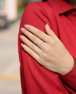 Elegantly worn S925 sterling silver half eternity ring featuring sparkling moissanite stones