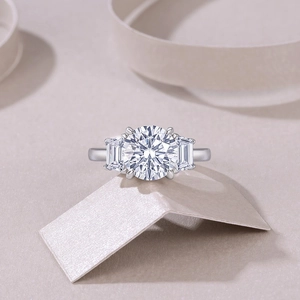 Detailed close-up of a S925 sterling silver three-stone ring with a brilliant round moissanite