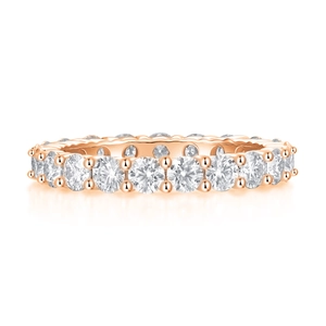 Detailed close-up of rose gold eternity ring with round brilliant-cut moissanite stones