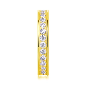 Close-up of eternity band ring with channel-set round stones in golden finish