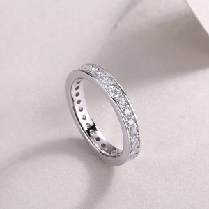 Close-up of S925 sterling silver eternity ring with pavé-set round moissanite stones